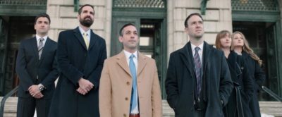 Attorneys on steps looking at sky