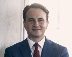 man smiling with arms folded